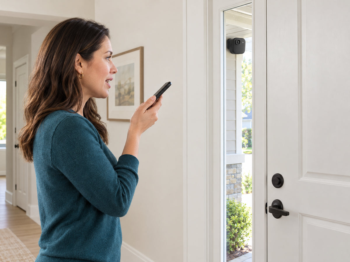 Wireless Outdoor Security Camera Designed, woman standing inside hallway speaking toward her phone